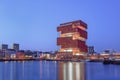 MAS Museum Antwerp at twilight, reflected in water